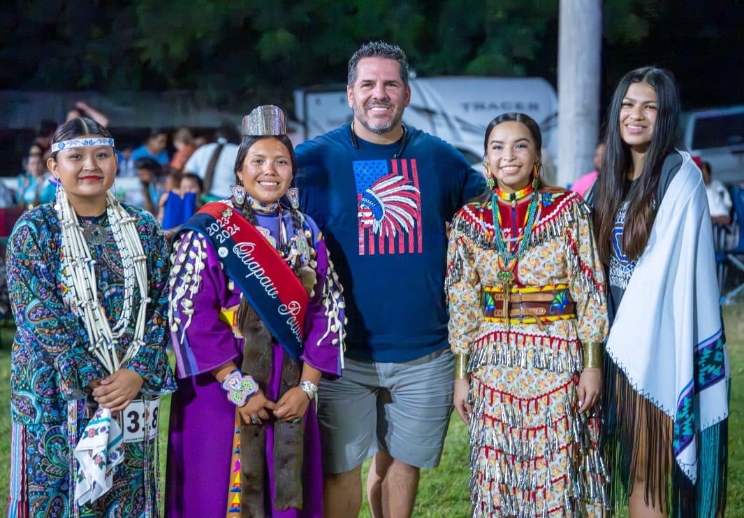 Dave with four dancers in regalia at the Quapaw Powwow, each of whom received a $500 award